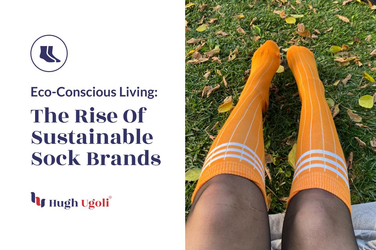 The image displays a pair of feet clad in bright orange knee-high socks with white stripes, resting on green grass scattered with fallen leaves.